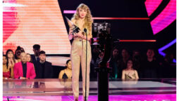 Taylor Swift Makes Surprise AMAs Appearance in Golden Jumpsuit