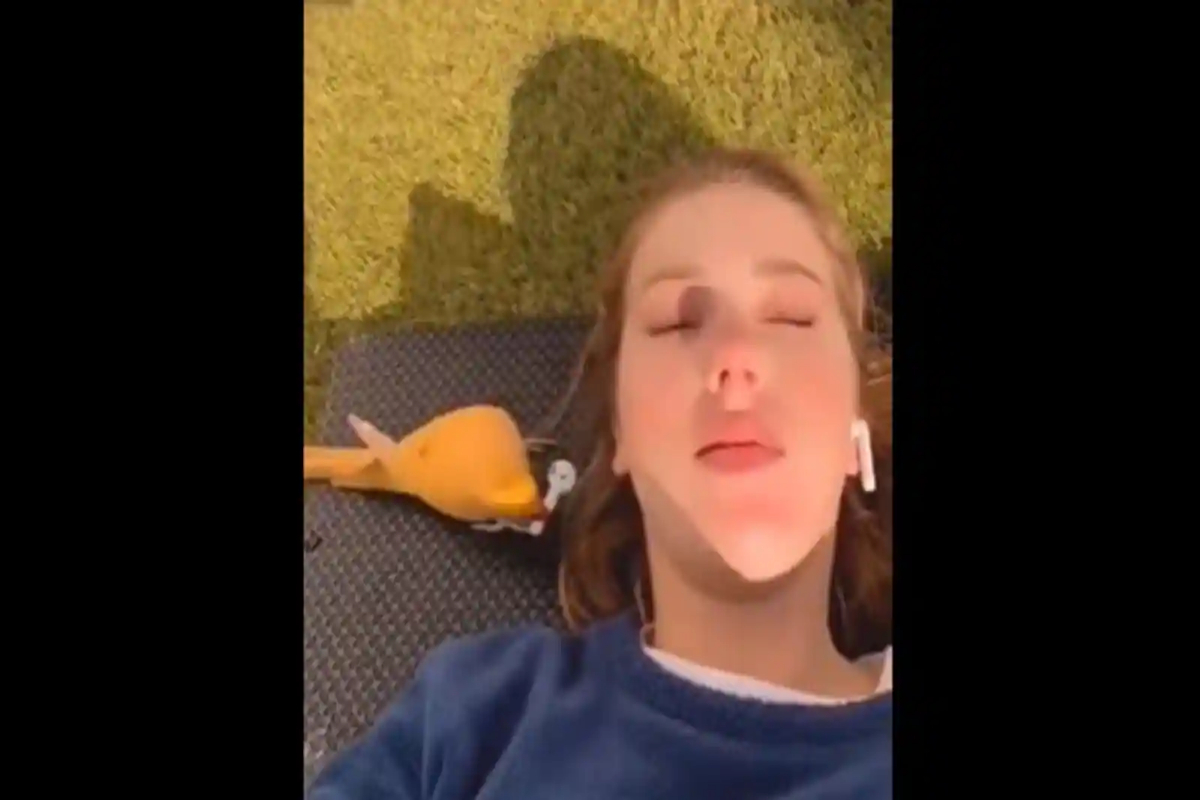 Bird steals a woman's earbud