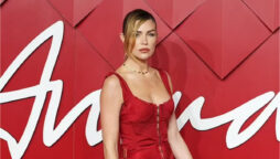 Abbey Clancy shows off her slim figure in bright red dress at British Fashion Awards