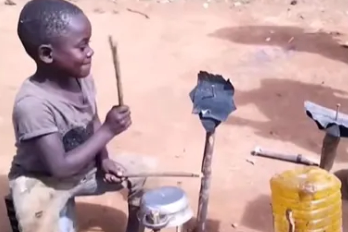 Young boy plays drums