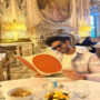 Kartik Aaryan poses smiling while reading menu at Paris hotel