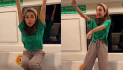 Woman dances in metro coach