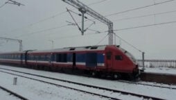 Train travels through the snow-clad valley of Jammu and Kashmir