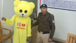 Man In A Teddy Bear Costume Dances At A Railway Overpass