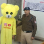 Man In A Teddy Bear Costume Dances At A Railway Overpass