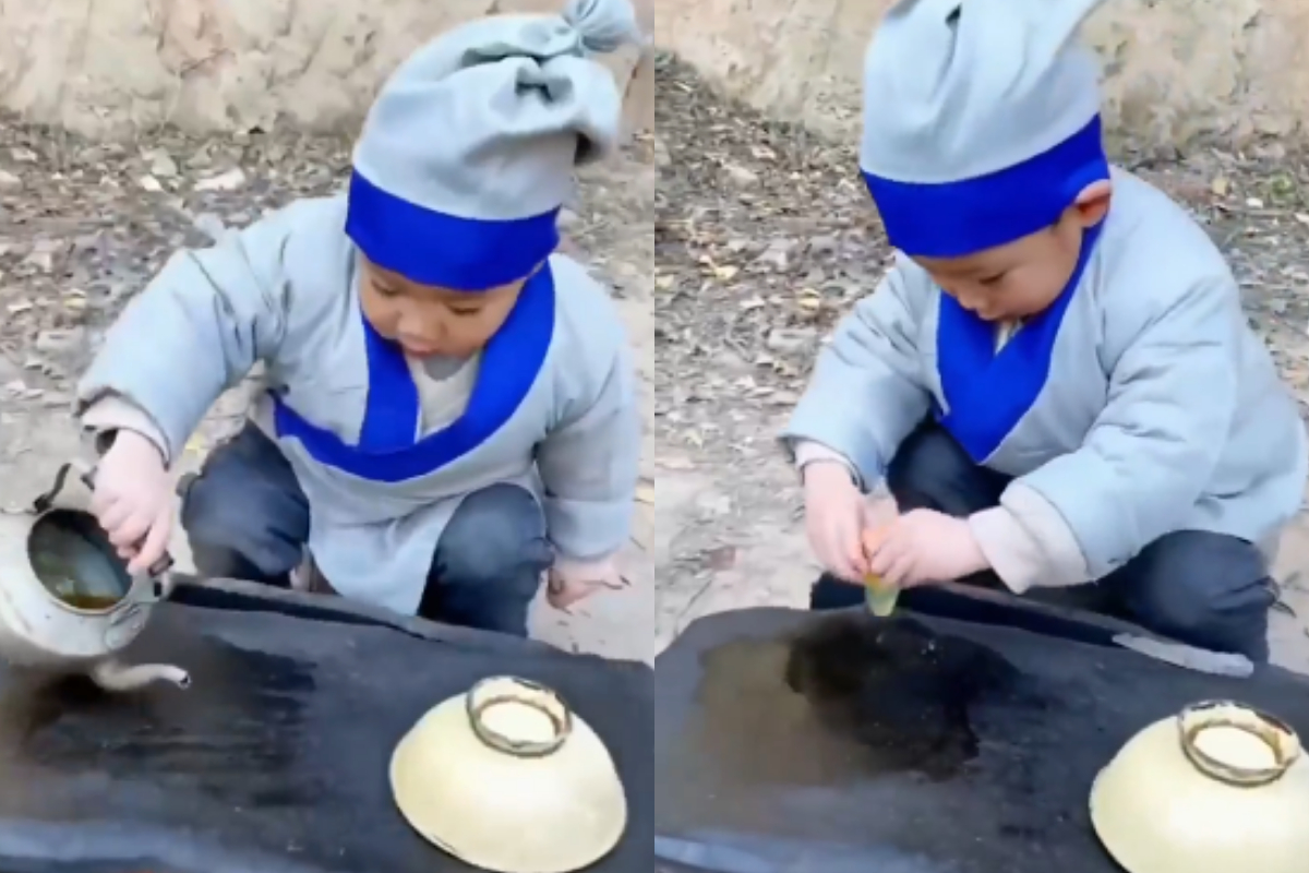 young child making sandwich