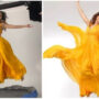 Samantha dressed in a yellow gown, hops on a trampoline