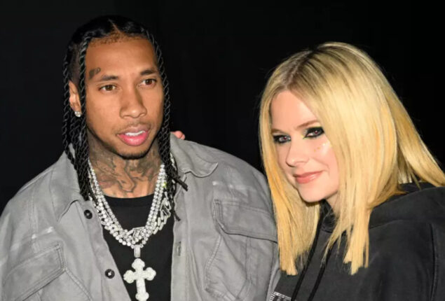 Tyga presents Avril Lavigne with a diamond chain