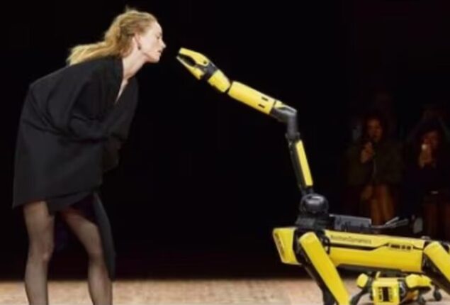 Robots walk the ramp with models at Paris Fashion Week