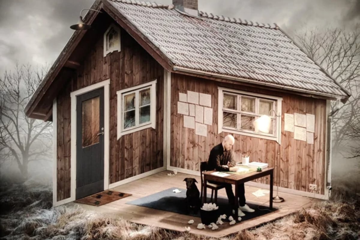 Can you determine if this man is sitting inside the home or outside?