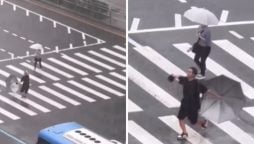 Man finds joy in the rain, dances his way across the road