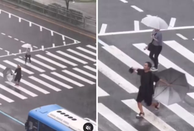 Man finds joy in the rain, dances his way across the road