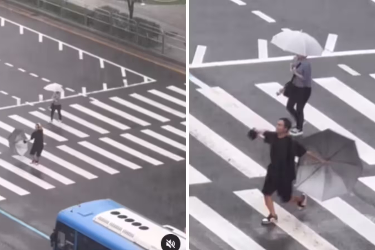Man finds joy in the rain, dances his way across the road
