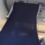 Passenger creates DIY VIP section in economy class with blanket
