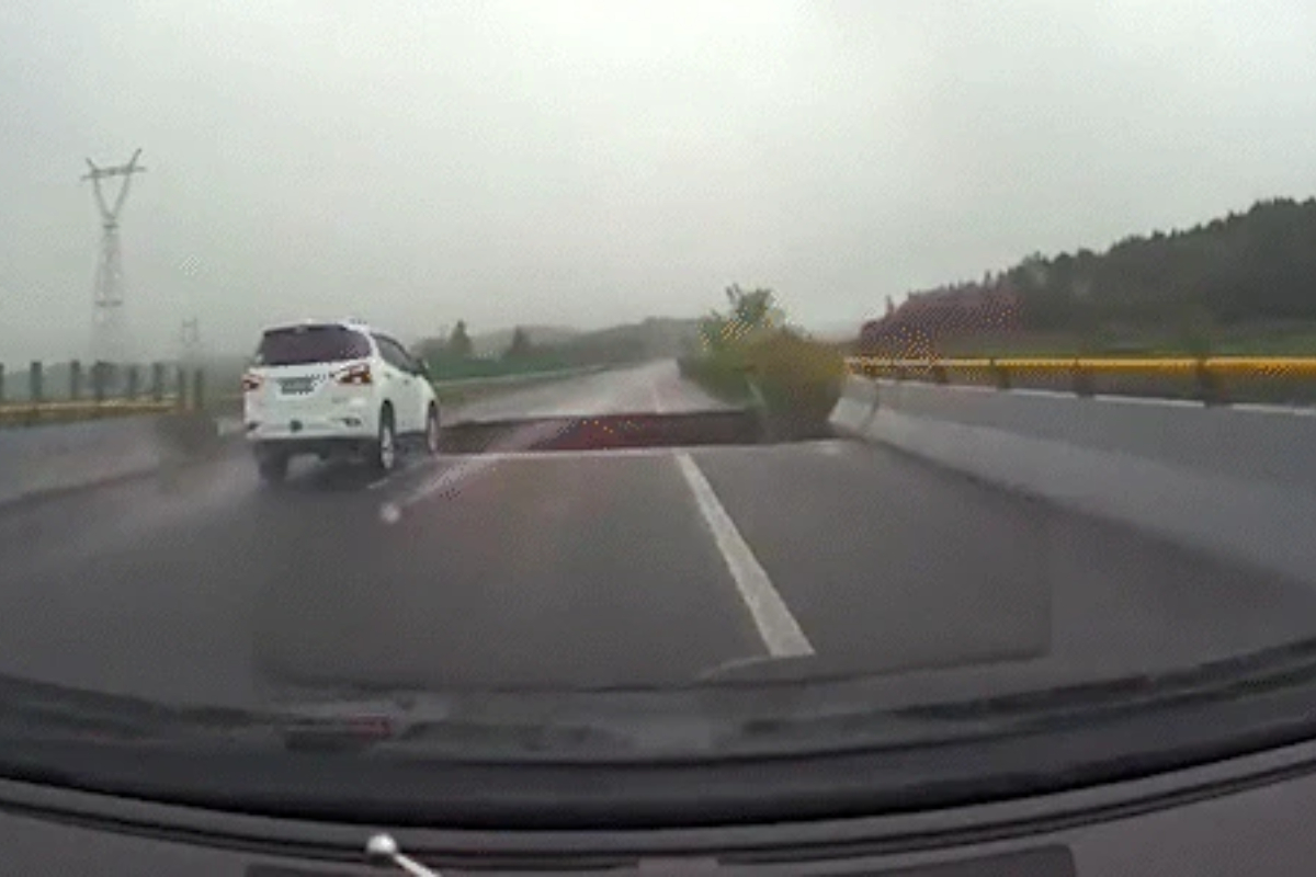 Car Falls into Crater After Heavy Rain Causes Bridge to Collapse