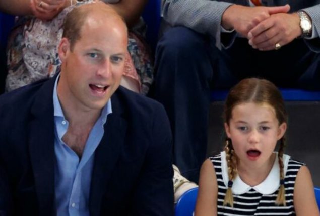 Prince William using Princess Charlotte as shield