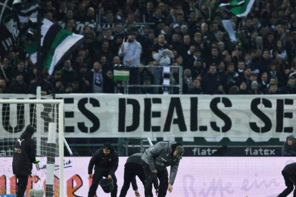 Bundesliga fans shower pitch with chocolate coins in investment deal protest