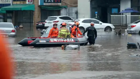 South Korean floods and landslides leave at least 14 dead and 12 missing