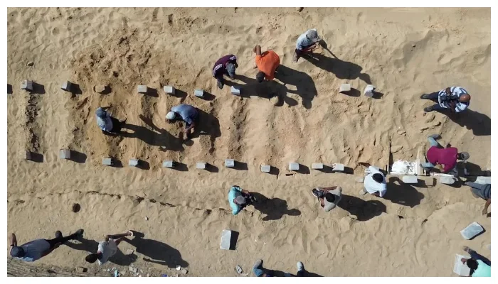 At mass burial in Gaza, Palestinians mourn the unknown dead.